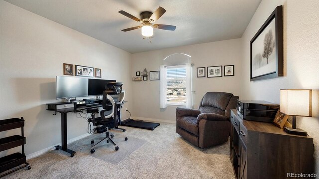 office space featuring ceiling fan and light colored carpet