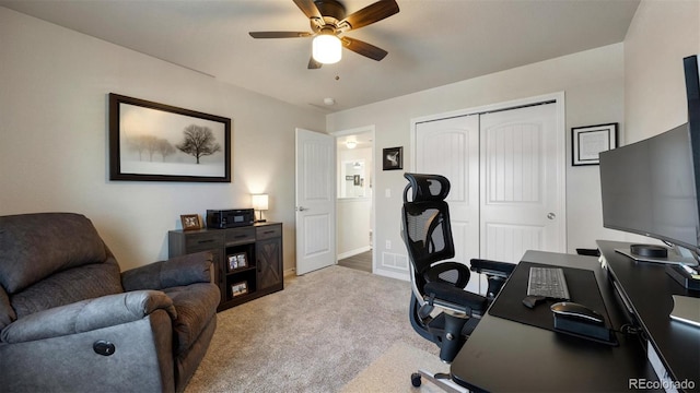 office space with light carpet and ceiling fan