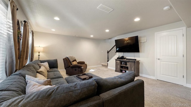 living room featuring light colored carpet and a textured ceiling