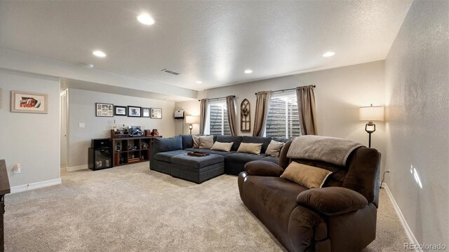 carpeted living room with a textured ceiling