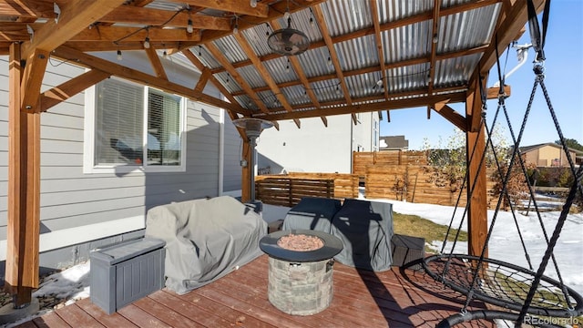 snow covered deck with a fire pit