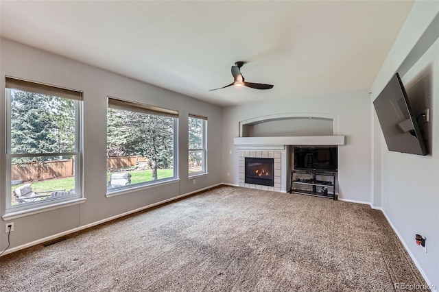 11321 Mesa Verde Pl, Parker, CO 80138 - unfurnished living room featuring a ceiling fan, carpet floors, a tile fireplace, and baseboards
