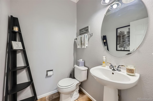 11321 Mesa Verde Pl, Parker, CO 80138 - half bathroom featuring toilet, a sink, baseboards, and tile patterned floors