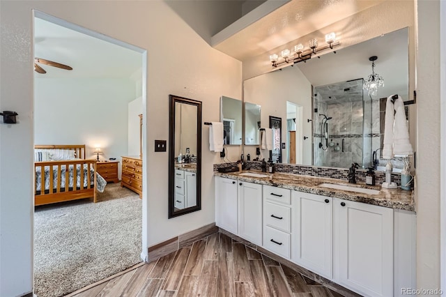 11321 Mesa Verde Pl, Parker, CO 80138 - full bath featuring a shower stall, a ceiling fan, double vanity, wood finished floors, and baseboards