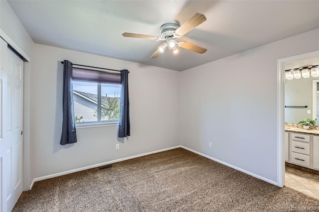 11321 Mesa Verde Pl, Parker, CO 80138 - unfurnished bedroom with light carpet, a closet, ensuite bath, and baseboards