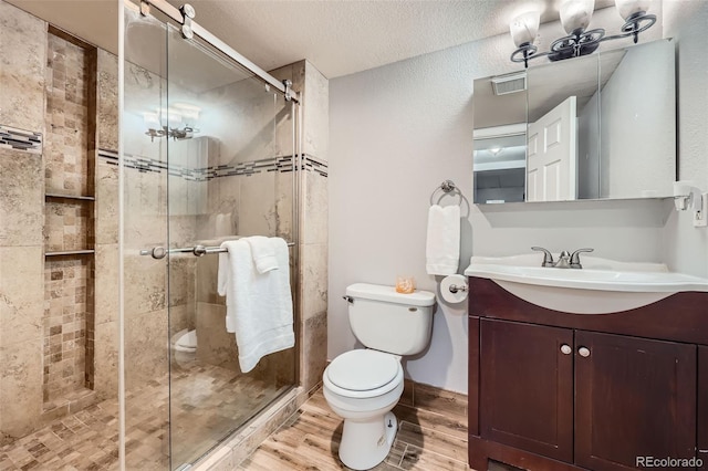11321 Mesa Verde Pl, Parker, CO 80138 - full bath with toilet, wood finished floors, vanity, a shower stall, and a textured ceiling