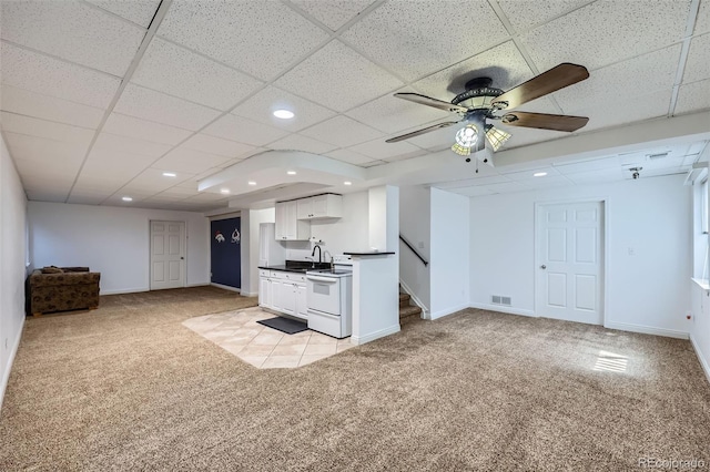 11321 Mesa Verde Pl, Parker, CO 80138 - kitchen featuring open floor plan, light colored carpet, a sink, white cabinets, and white electric stove