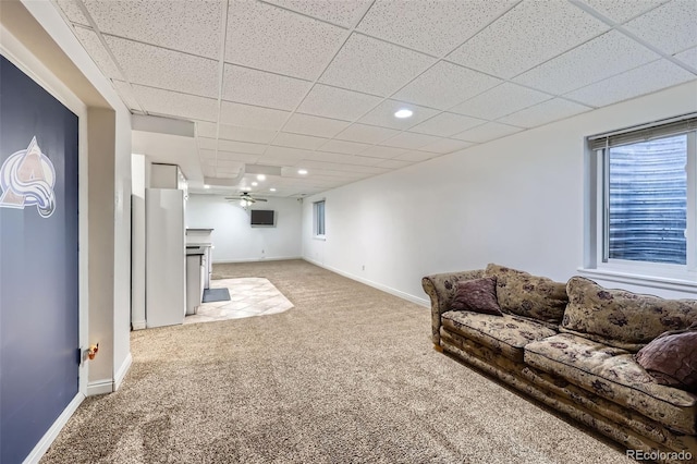 11321 Mesa Verde Pl, Parker, CO 80138 - carpeted living area featuring a drop ceiling, a ceiling fan, baseboards, recessed lighting, and a fireplace