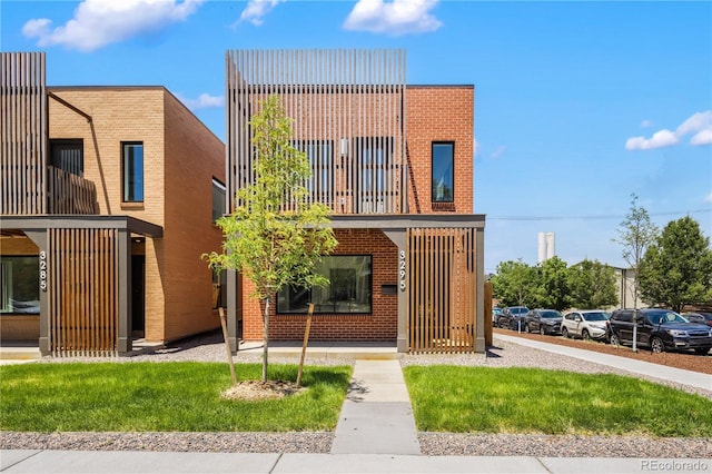 3295 Lawrence St, Denver, CO 80205 - view of front of house featuring a balcony and brick siding