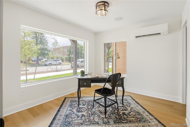3295 Lawrence St, Denver, CO 80205 - office area featuring a wall mounted air conditioner, plenty of natural light, and light wood-style floors