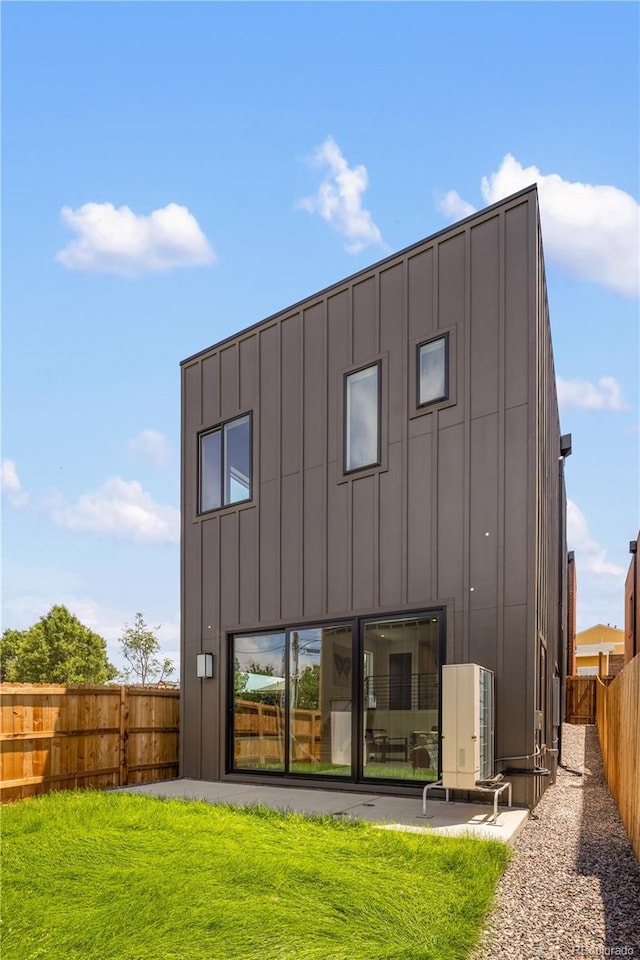 3295 Lawrence St, Denver, CO 80205 - back of house featuring board and batten siding and a fenced backyard