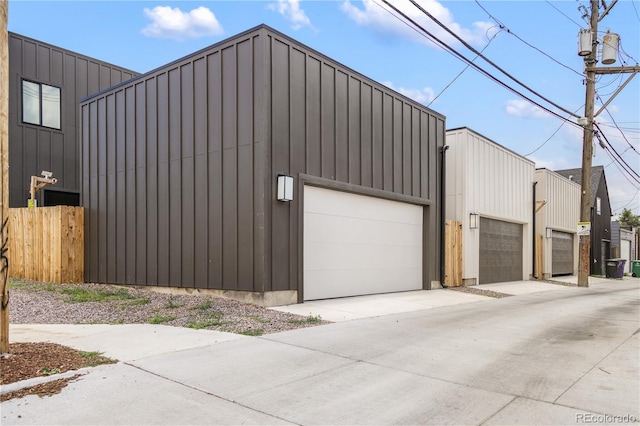 3295 Lawrence St, Denver, CO 80205 - view of side of home with board and batten siding and a detached garage