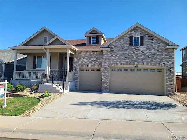 craftsman inspired home with covered porch, an attached garage, and driveway