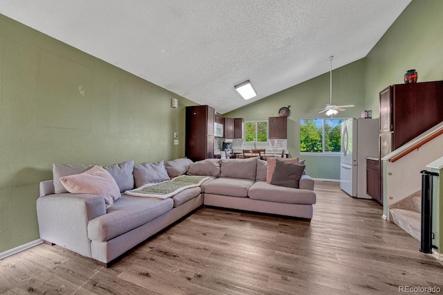3730 Hazelwood Ct, Colorado Springs, CO 80918 - living room with light wood-style flooring, a textured ceiling, high vaulted ceiling, stairway, and a ceiling fan