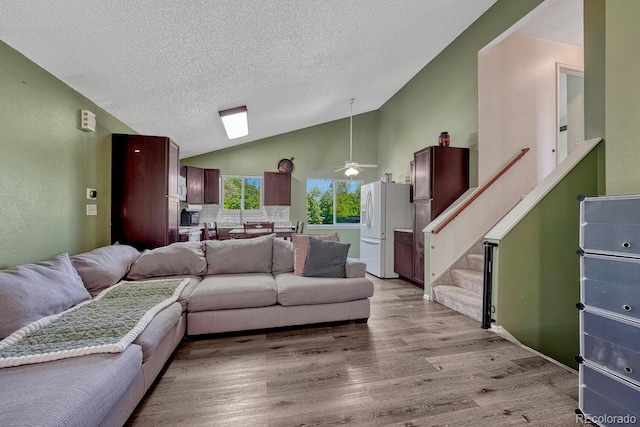 3730 Hazelwood Ct, Colorado Springs, CO 80918 - living area with a textured ceiling, light wood-type flooring, a ceiling fan, stairway, and high vaulted ceiling
