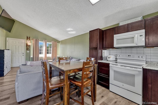 3730 Hazelwood Ct, Colorado Springs, CO 80918 - kitchen featuring white appliances, a textured ceiling, lofted ceiling, light wood-style flooring, and open floor plan