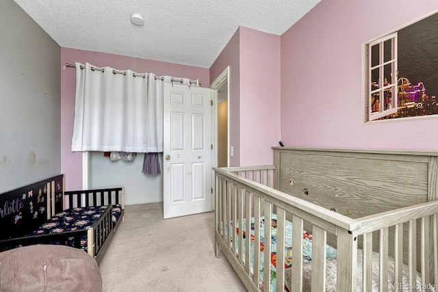 3730 Hazelwood Ct, Colorado Springs, CO 80918 - bedroom featuring carpet, a textured ceiling, and a crib