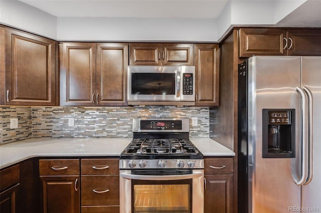 kitchen with decorative backsplash, appliances with stainless steel finishes, and dark brown cabinets