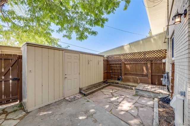 view of patio with a storage shed