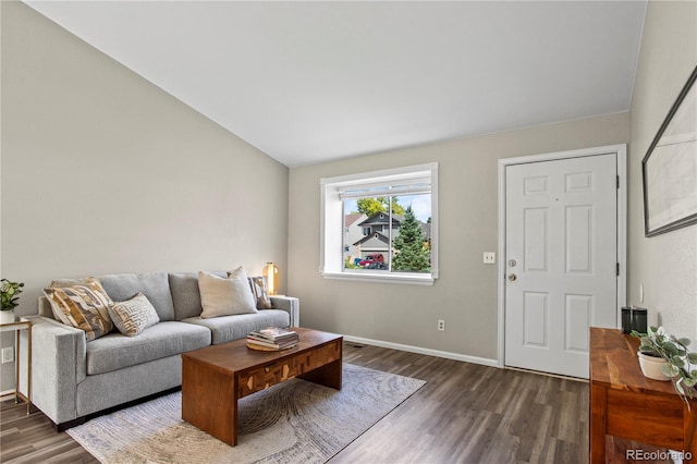 living room featuring lofted ceiling and dark hardwood / wood-style floors