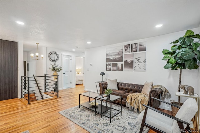 living room with a chandelier and light hardwood / wood-style flooring