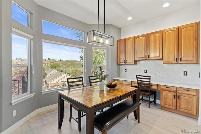 828 Rabbit Run Dr, Golden, CO 80401 - dining space featuring recessed lighting, built in desk, and a chandelier