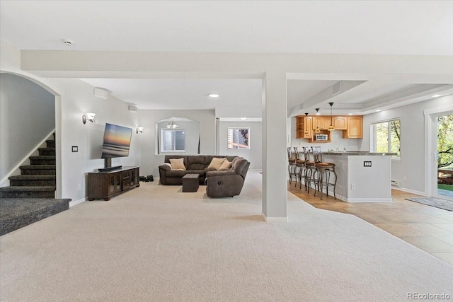 828 Rabbit Run Dr, Golden, CO 80401 - living area with light carpet, arched walkways, stairs, recessed lighting, and bar area