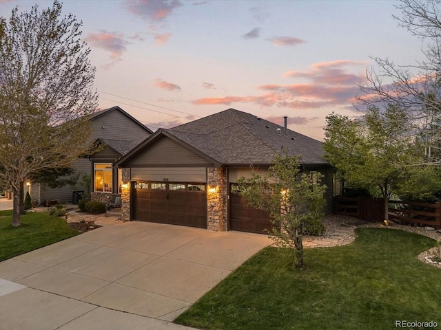 828 Rabbit Run Dr, Golden, CO 80401 - view of front of home featuring an attached garage, driveway, a shingled roof, and stone siding