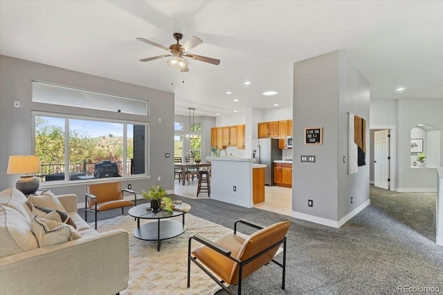 828 Rabbit Run Dr, Golden, CO 80401 - living area with ceiling fan, recessed lighting, light carpet, and arched walkways