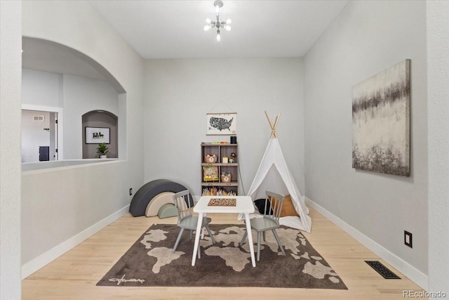 828 Rabbit Run Dr, Golden, CO 80401 - rec room with arched walkways and wood finished floors