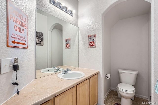 bathroom featuring vanity, toilet, and tile patterned flooring