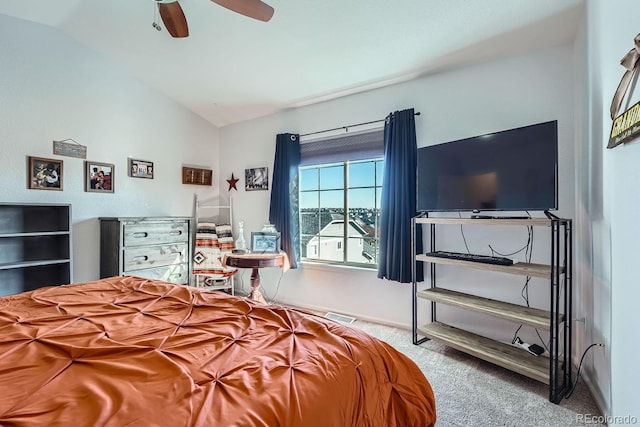 carpeted bedroom with ceiling fan and vaulted ceiling