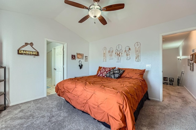 carpeted bedroom with ceiling fan, ensuite bath, and vaulted ceiling