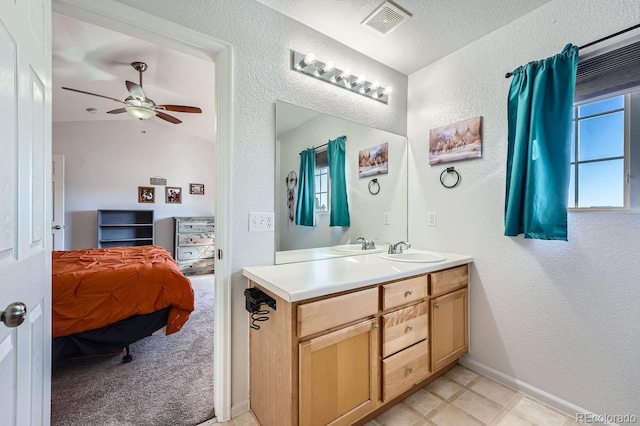 bathroom featuring vanity, a textured ceiling, and ceiling fan