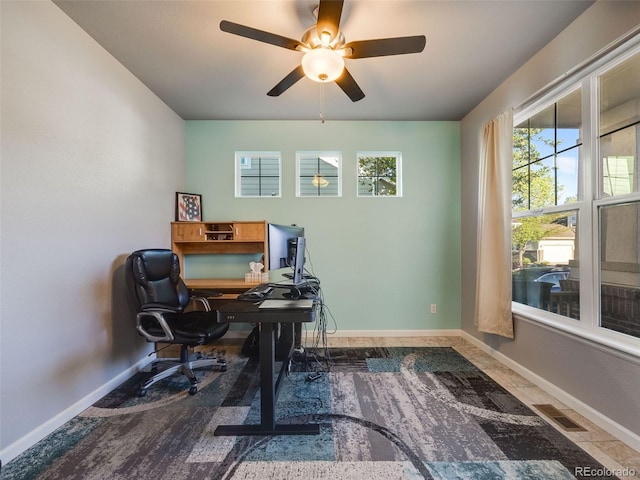 office area featuring ceiling fan and baseboards