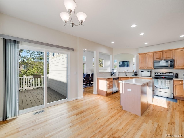 kitchen featuring stainless steel appliances, light wood-type flooring, light countertops, plenty of natural light, and recessed lighting