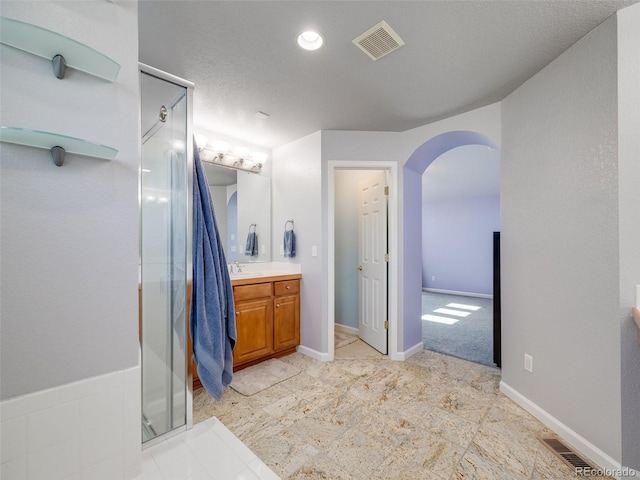 full bathroom featuring a shower stall and vanity