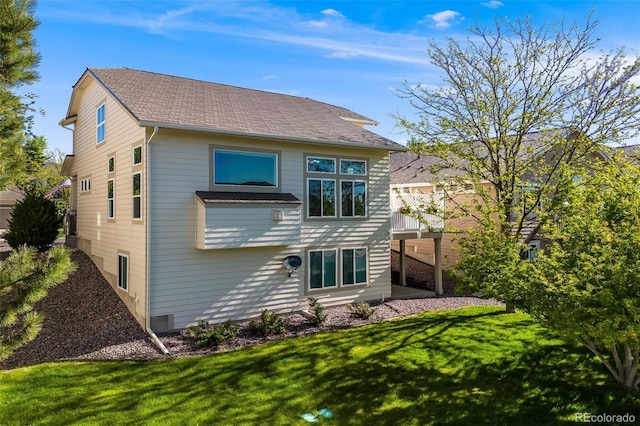 rear view of property with a yard