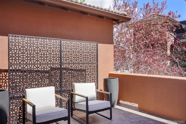 view of patio featuring a balcony