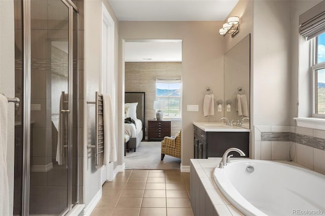 ensuite bathroom featuring a garden tub, a shower stall, vanity, tile patterned floors, and ensuite bath