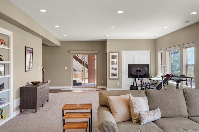 living room with recessed lighting, visible vents, plenty of natural light, and carpet