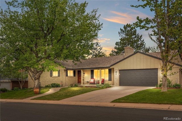 single story home with covered porch, brick siding, and a lawn