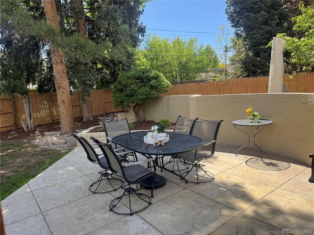 view of patio with outdoor dining area and a fenced backyard