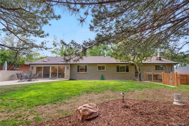 rear view of property featuring a patio area and brick siding