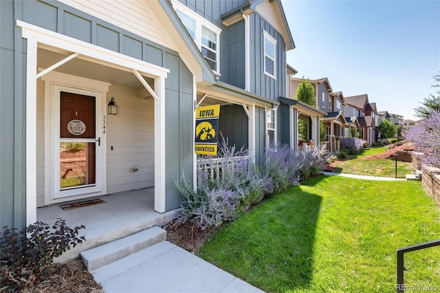 doorway to property with a yard and a porch