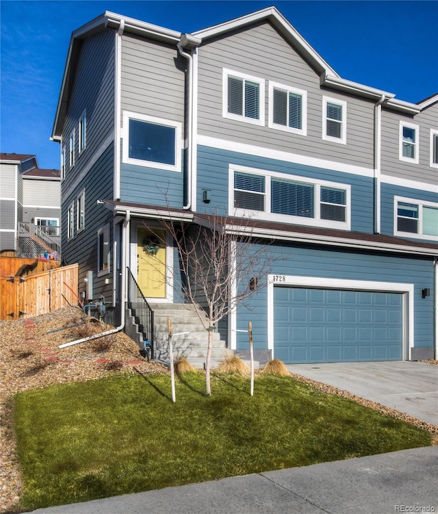 view of front of property featuring a garage and a front lawn