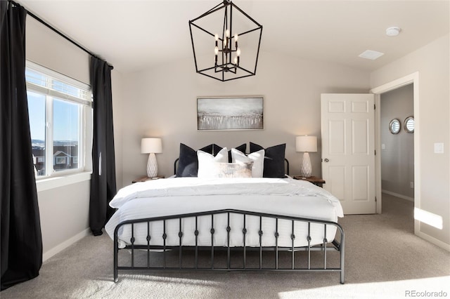 bedroom featuring lofted ceiling, carpet floors, and an inviting chandelier