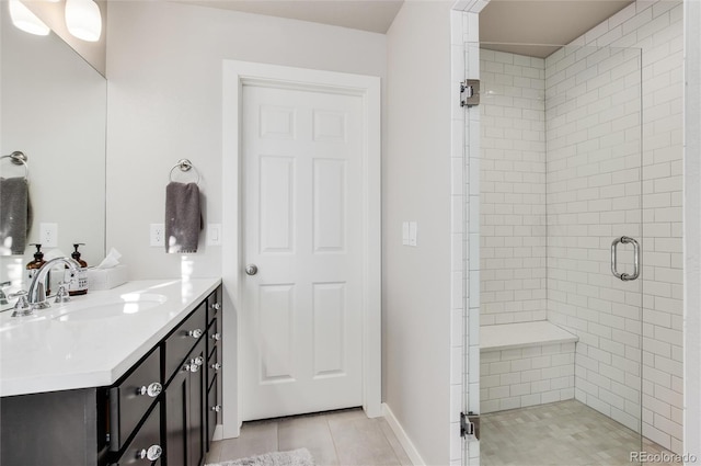 bathroom featuring tile patterned floors, vanity, and a shower with shower door