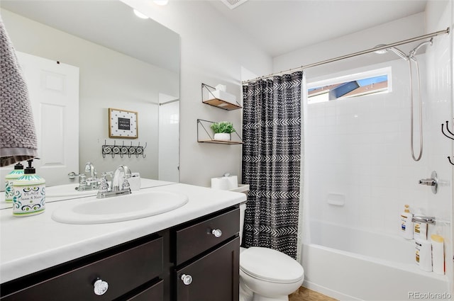 full bathroom with shower / tub combo with curtain, vanity, and toilet