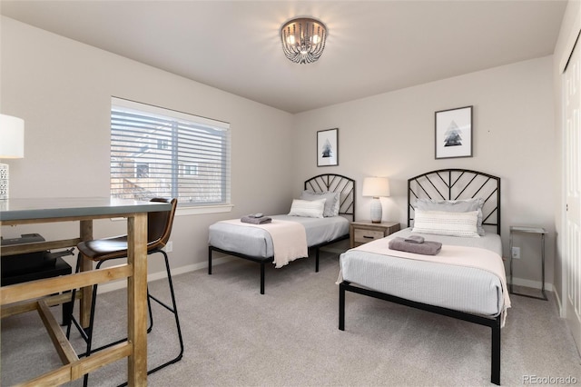 carpeted bedroom featuring a chandelier